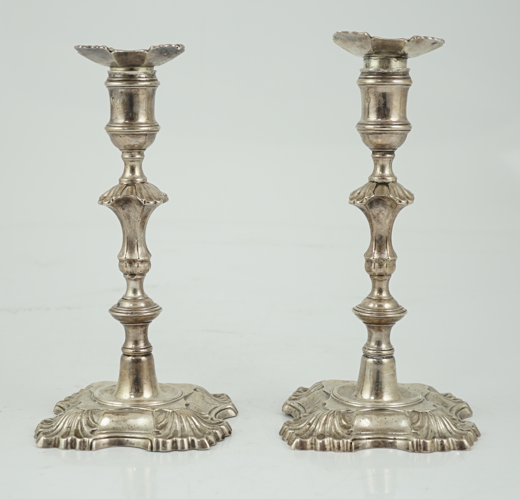 A pair of George II cast silver candlesticks by William Gould